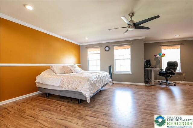 bedroom with wood finished floors, baseboards, ornamental molding, an office area, and recessed lighting