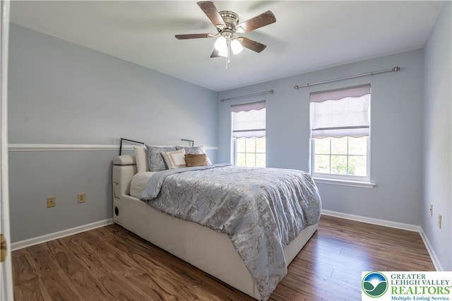 bedroom featuring wood finished floors, baseboards, and ceiling fan