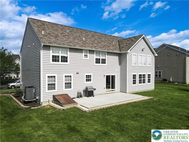 back of house featuring a patio, a yard, central AC unit, and a shingled roof