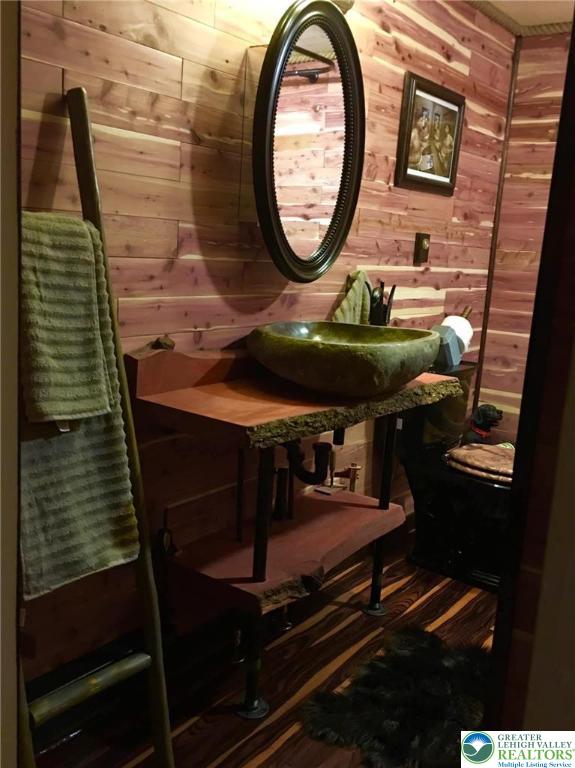 999 Glass St, Pen Argyl Borough, PA 18072 - half bathroom featuring wooden walls