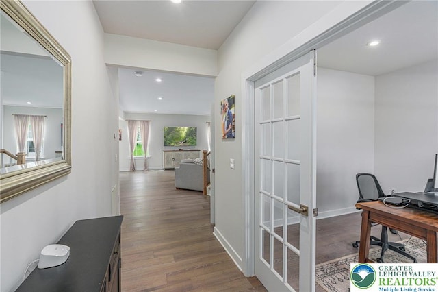 corridor featuring an office area, wood finished floors, recessed lighting, and baseboards