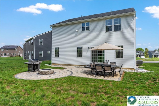 back of house featuring an outdoor fire pit, a patio area, a yard, and central AC