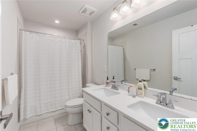 full bath with tile patterned flooring, toilet, and double vanity