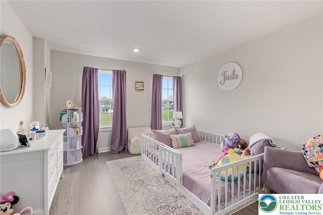bedroom with light wood finished floors and recessed lighting