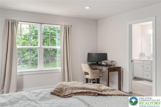 bedroom featuring a sink and baseboards
