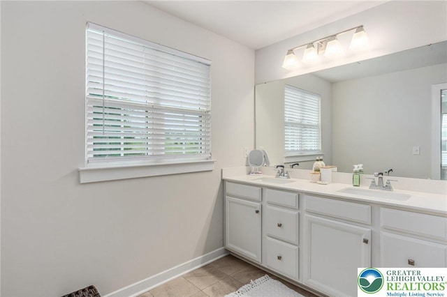 full bathroom featuring tile patterned flooring, double vanity, and baseboards