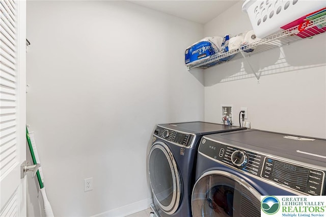 laundry room featuring separate washer and dryer, baseboards, and tile patterned floors