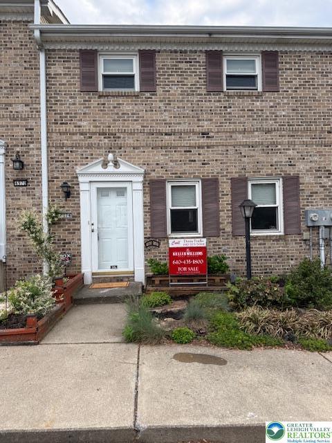 view of property with brick siding
