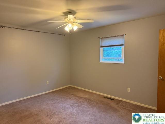 unfurnished room featuring a ceiling fan, carpet floors, and baseboards