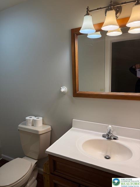 bathroom featuring vanity and toilet