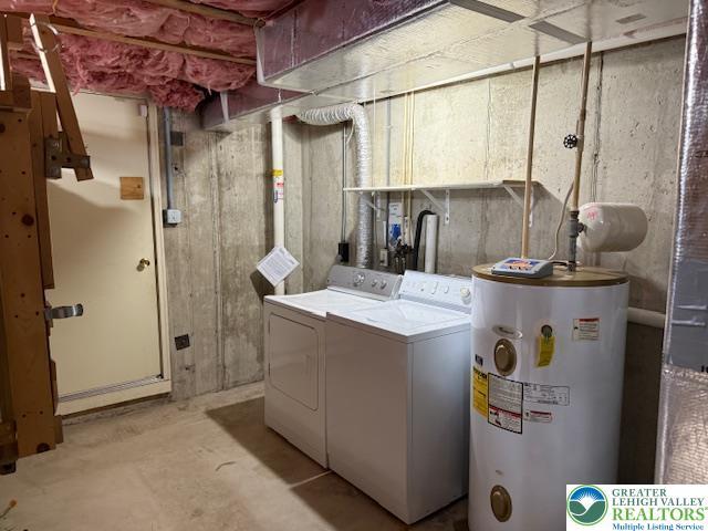 clothes washing area with water heater and independent washer and dryer