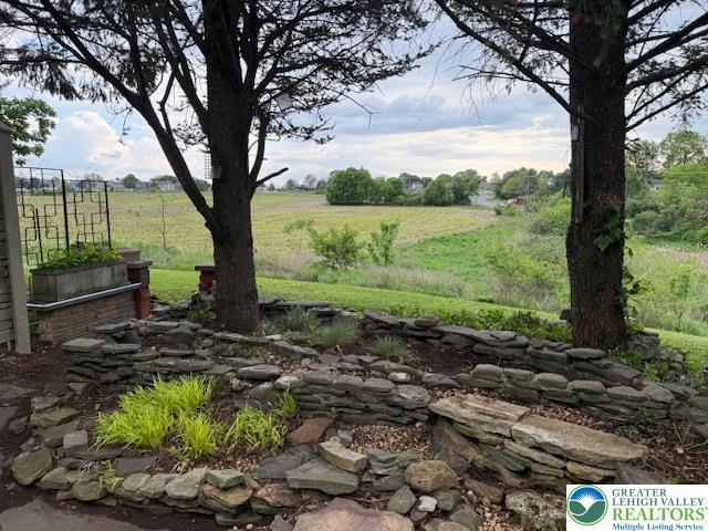 view of yard with a view of countryside and fence