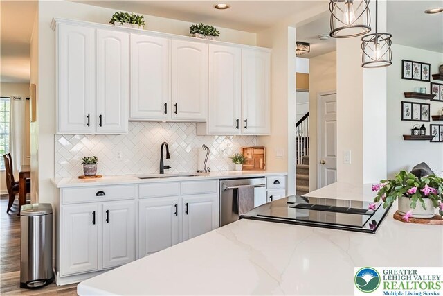 kitchen featuring a sink, dishwasher, white cabinets, decorative backsplash, and recessed lighting