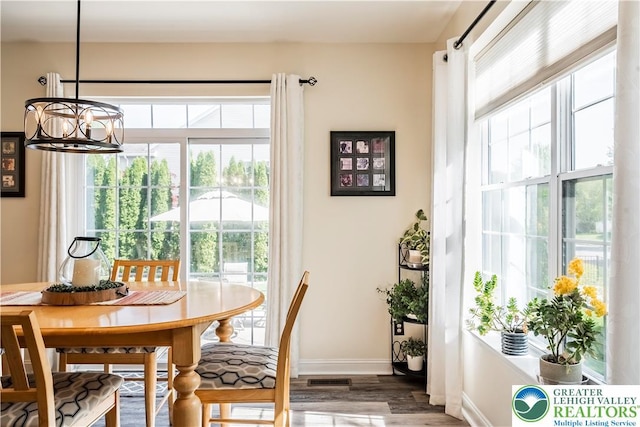 dining space featuring wood finished floors and baseboards