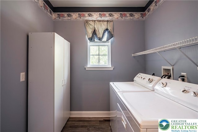 washroom with washer and dryer, baseboards, and dark wood finished floors