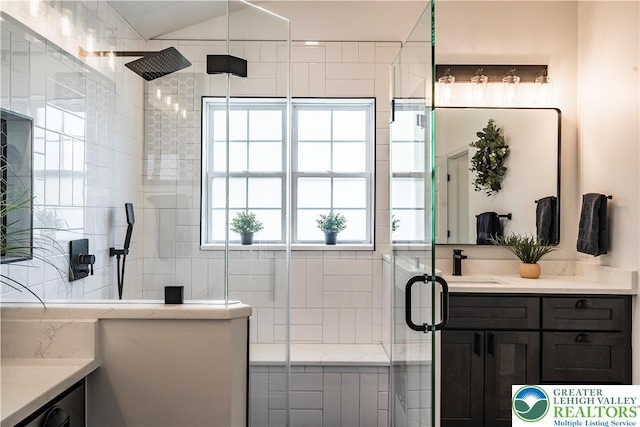 bathroom with vanity and a tile shower