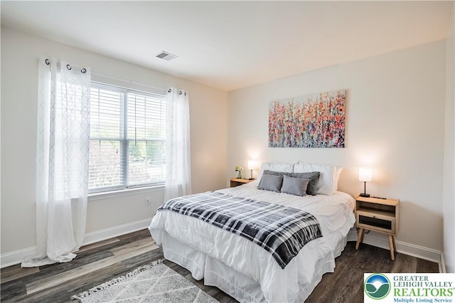 bedroom featuring wood finished floors and baseboards