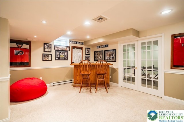 indoor dry bar featuring a baseboard radiator, carpet, french doors, baseboards, and recessed lighting