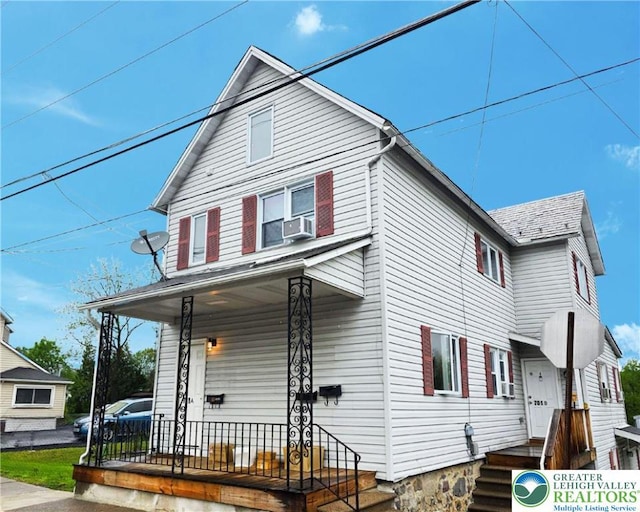 traditional style home featuring a porch and cooling unit