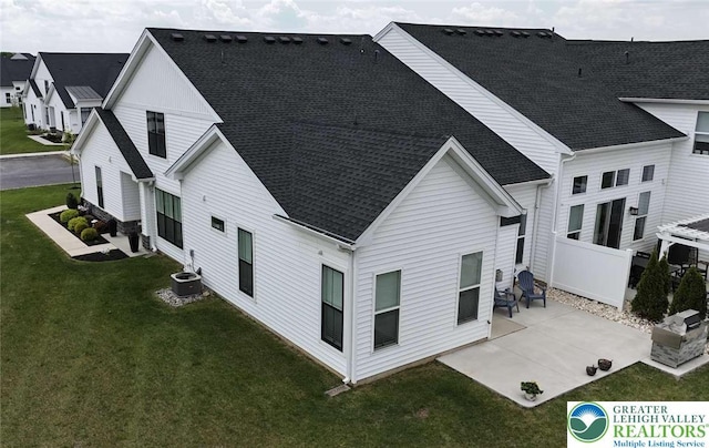 6907 Cedar Dr, East Allen Twp, PA 18014 - back of house with roof with shingles, a patio, a lawn, and cooling unit