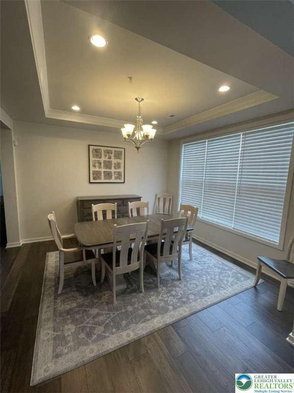 6907 Cedar Dr, East Allen Twp, PA 18014 - dining space featuring a tray ceiling, baseboards, a chandelier, ornamental molding, and dark wood-style floors