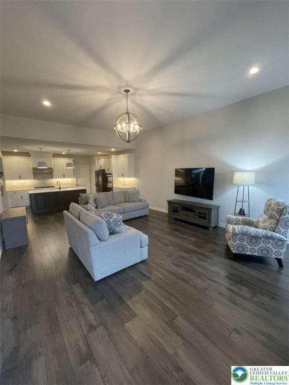 6907 Cedar Dr, East Allen Twp, PA 18014 - living area with dark wood-style flooring, baseboards, a chandelier, and recessed lighting