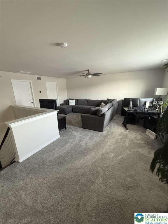 6907 Cedar Dr, East Allen Twp, PA 18014 - carpeted living room featuring a desk and ceiling fan