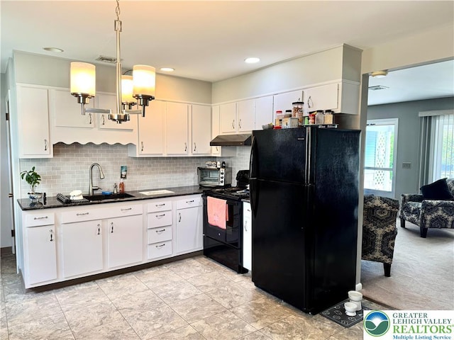 8173 Holbens Valley Rd, Weisenberg Twp, PA 18066 - kitchen featuring black appliances, under cabinet range hood, a sink, dark countertops, and white cabinets
