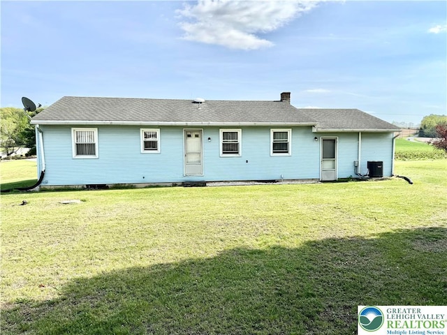8173 Holbens Valley Rd, Weisenberg Twp, PA 18066 - rear view of property with a yard, a chimney, and cooling unit