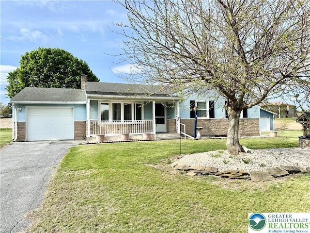 8173 Holbens Valley Rd, Weisenberg Twp, PA 18066 - ranch-style house featuring a porch, an attached garage, asphalt driveway, and a front lawn