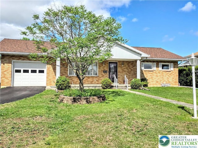 ranch-style house with a garage, brick siding, asphalt driveway, and a front yard