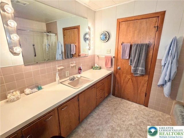 bathroom featuring ornamental molding, tile walls, vanity, and a shower with curtain