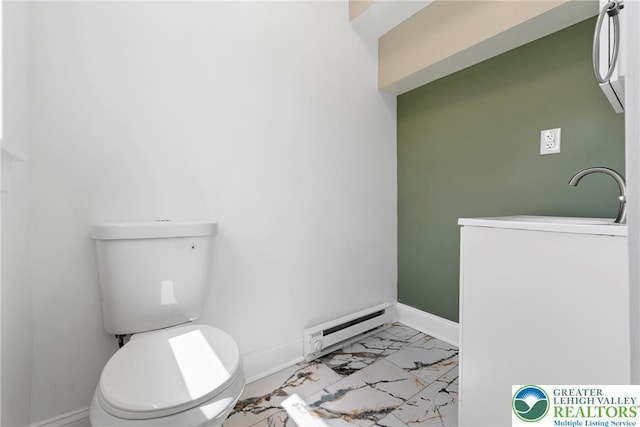 410 E Hamilton St, Allentown City, PA 18109 - bathroom featuring a baseboard radiator, washer / dryer, marble look tiles, baseboards, and toilet