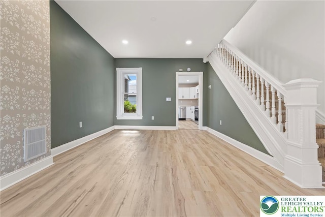 410 E Hamilton St, Allentown City, PA 18109 - unfurnished living room featuring wallpapered walls, stairs, wood finished floors, baseboards, and recessed lighting