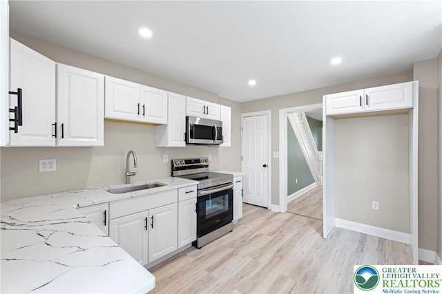 410 E Hamilton St, Allentown City, PA 18109 - kitchen with appliances with stainless steel finishes, a sink, light stone countertops, white cabinetry, and recessed lighting