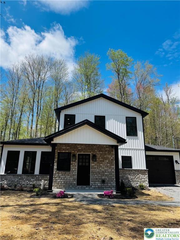 211 Maxatawny Dr, Coolbaugh Twp, PA 18347 - modern farmhouse style home with driveway and stone siding