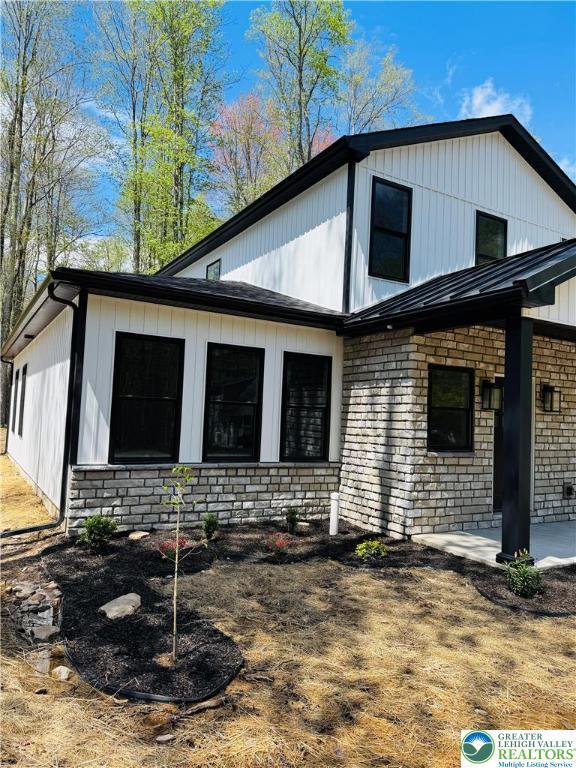 211 Maxatawny Dr, Coolbaugh Twp, PA 18347 - back of house featuring brick siding