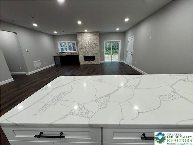 211 Maxatawny Dr, Coolbaugh Twp, PA 18347 - unfurnished living room with dark wood-style floors, a fireplace, recessed lighting, and baseboards