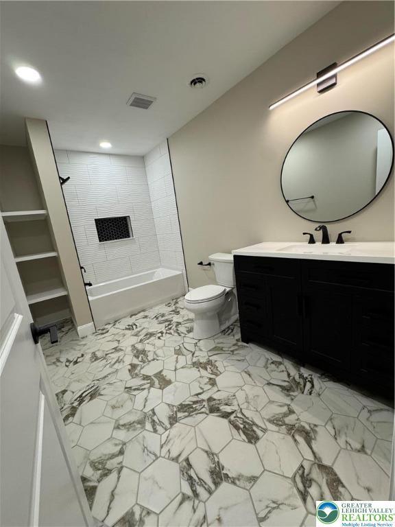 211 Maxatawny Dr, Coolbaugh Twp, PA 18347 - bathroom with marble look tiles, toilet, vanity, recessed lighting, and washtub / shower combination