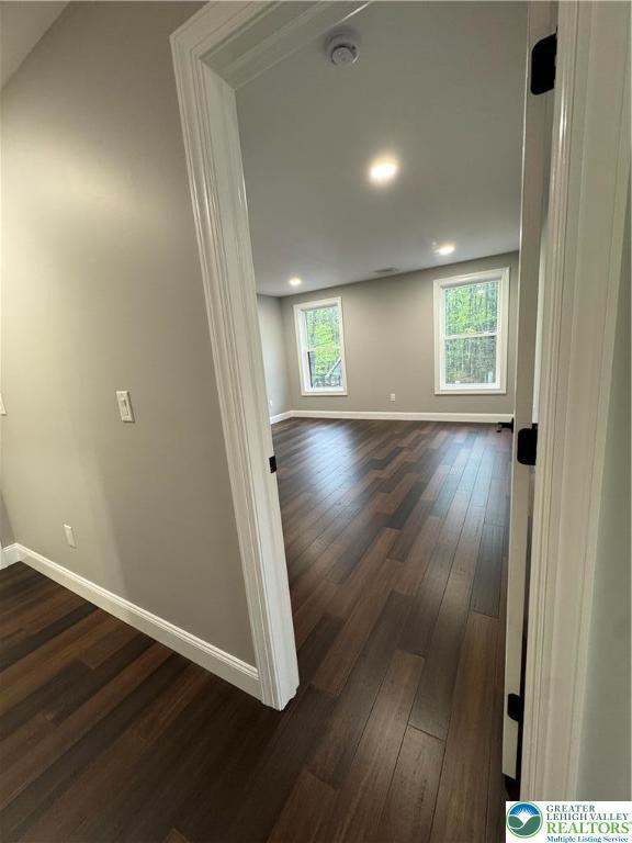 211 Maxatawny Dr, Coolbaugh Twp, PA 18347 - empty room with baseboards, dark wood-type flooring, a smoke detector, and recessed lighting