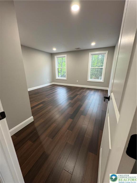211 Maxatawny Dr, Coolbaugh Twp, PA 18347 - empty room featuring dark wood-type flooring, baseboards, and recessed lighting