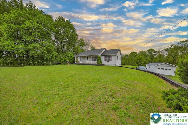 4579 W Mountain View Dr, Lehigh Twp, PA 18088 - view of front of property featuring a detached garage, a lawn, covered porch, an outbuilding, and view of scattered trees