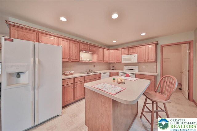 4579 W Mountain View Dr, Lehigh Twp, PA 18088 - kitchen with white appliances, a sink, light countertops, a center island, and recessed lighting
