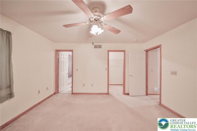 4579 W Mountain View Dr, Lehigh Twp, PA 18088 - unfurnished bedroom featuring light colored carpet, baseboards, a walk in closet, and ceiling fan