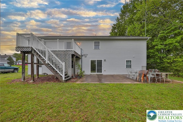4579 W Mountain View Dr, Lehigh Twp, PA 18088 - back of house at dusk with a yard, a patio, stairs, and a deck
