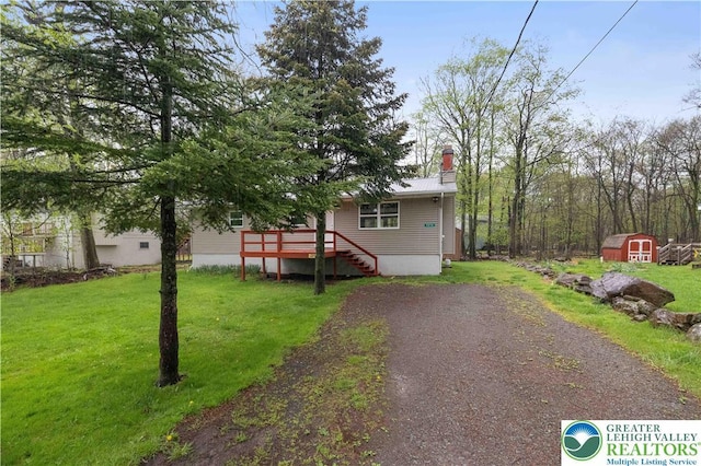 1918 Horseshoe, Coolbaugh Twp, PA 18466 - view of front of property with a shed, an outbuilding, a front lawn, and a wooden deck