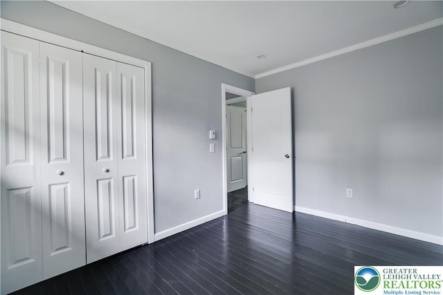 1918 Horseshoe, Coolbaugh Twp, PA 18466 - unfurnished bedroom with baseboards, dark wood-style floors, a closet, and ornamental molding