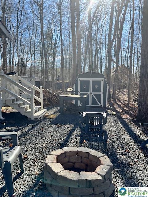 266 Maxatawny Dr, Coolbaugh Twp, PA 18347 - view of yard with a fire pit, an outdoor structure, and a storage shed