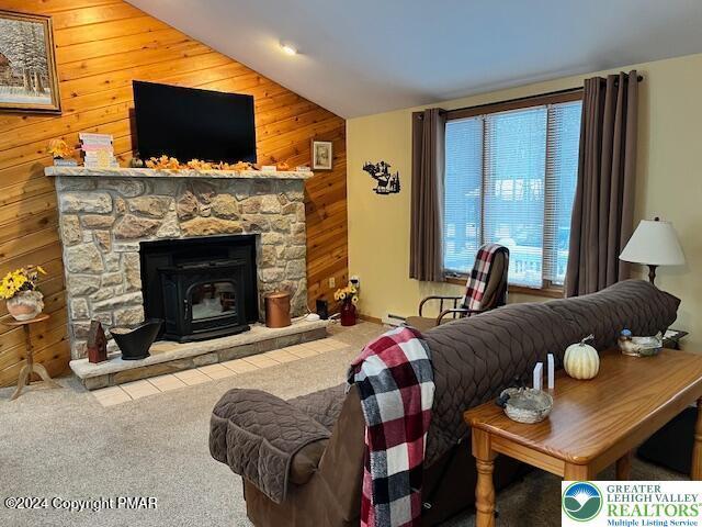 266 Maxatawny Dr, Coolbaugh Twp, PA 18347 - carpeted living area with wood walls, vaulted ceiling, and a baseboard radiator