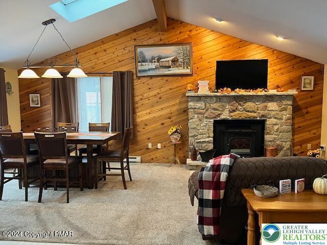 266 Maxatawny Dr, Coolbaugh Twp, PA 18347 - carpeted dining space featuring wooden walls and a skylight